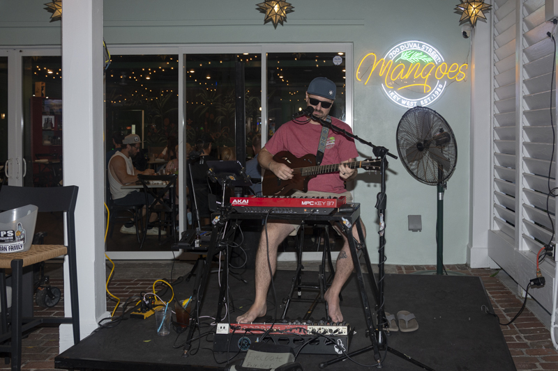 Jack Fivecoates performing live with guitar in Key West, Florida.